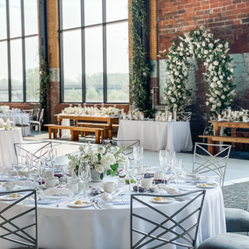 Wedding tables and chairs with floral and candle decorations